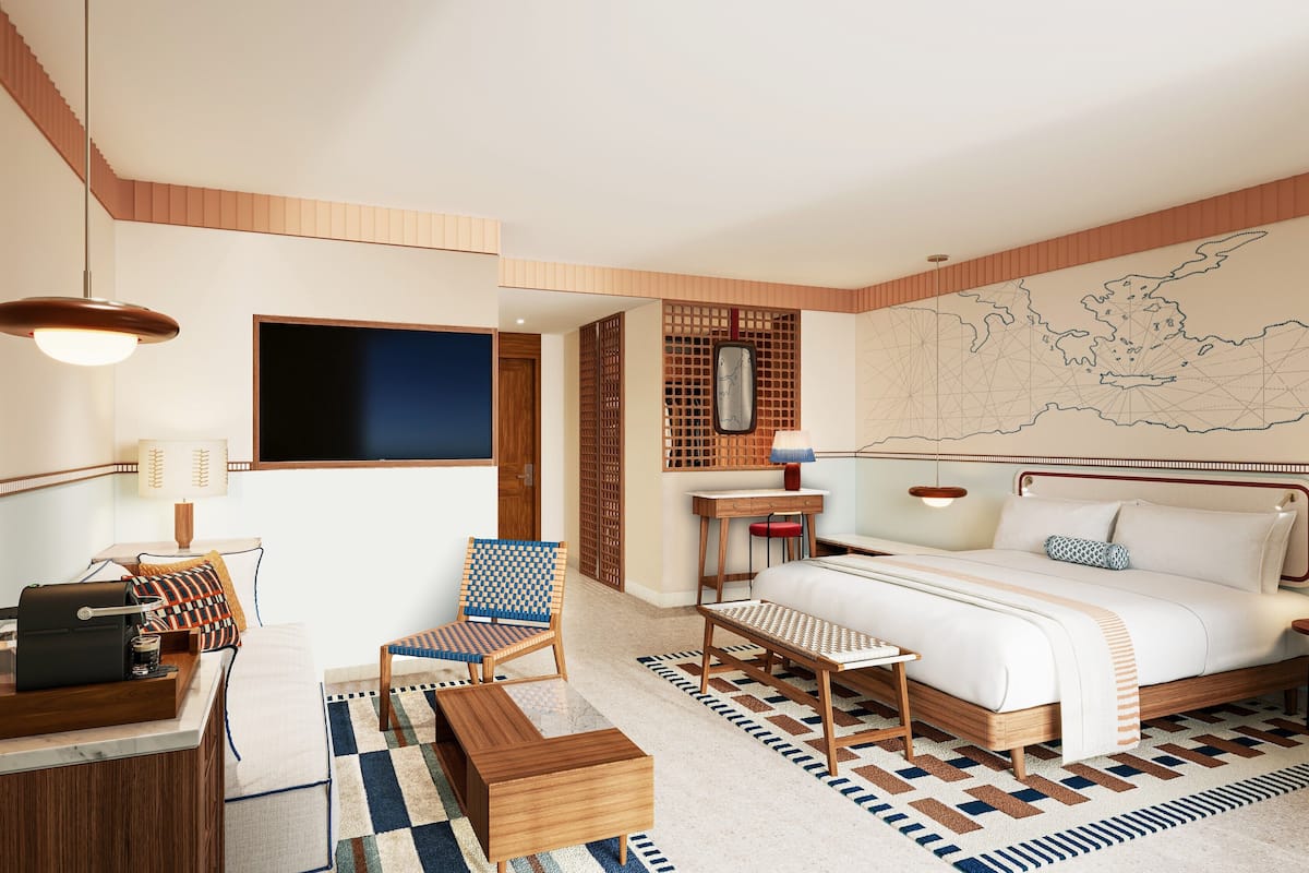 Habitación de hotel moderna con una cama grande, un escritorio, una silla y un mapa en la pared.