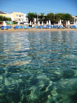 Relax on the beach with access to clear, shallow waters and comfortable lounge chairs.