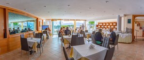 Enjoy dining in comfort with ample seating options and a view of the surrounding mountains and greenery.