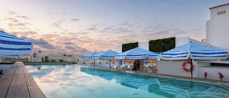 Seasonal outdoor pool, open 11:00 AM to 8:00 PM, pool umbrellas