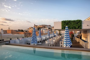Seasonal outdoor pool, open 10:00 AM to 6:00 PM, pool umbrellas