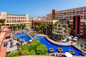 A resort with multiple swimming pools, a central waterfall feature, and surrounding palm trees. - Hotel Best Jacaranda (Adeje)