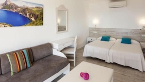 A hotel room with a bed, a sofa, a desk, and a nightstand. - Sun Club El Dorado (Llucmajor)