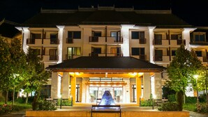 A multi-story hotel with a central entrance, a fountain, and a well-maintained garden. - Greenfield Hotel Golf & Spa (Buk)