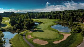 Un parcours de golf doté de bunkers, d’obstacles d’eau et d’un étang.