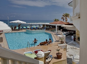 Seasonal outdoor pool, open 9:00 AM to 5:00 PM, pool umbrellas