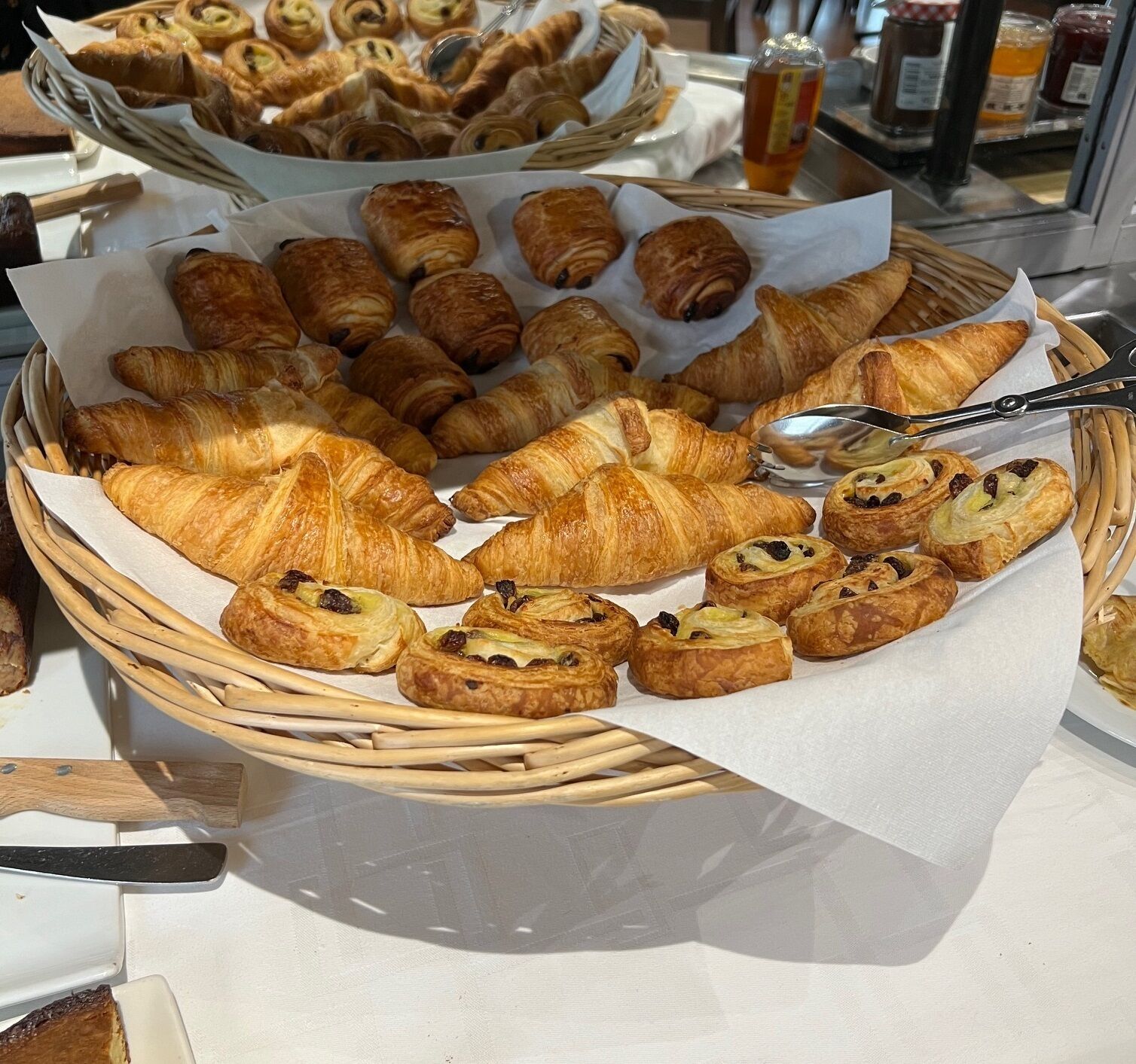 A variety of pastries arranged in baskets on a table.