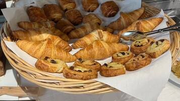 A variety of pastries arranged in baskets on a table.