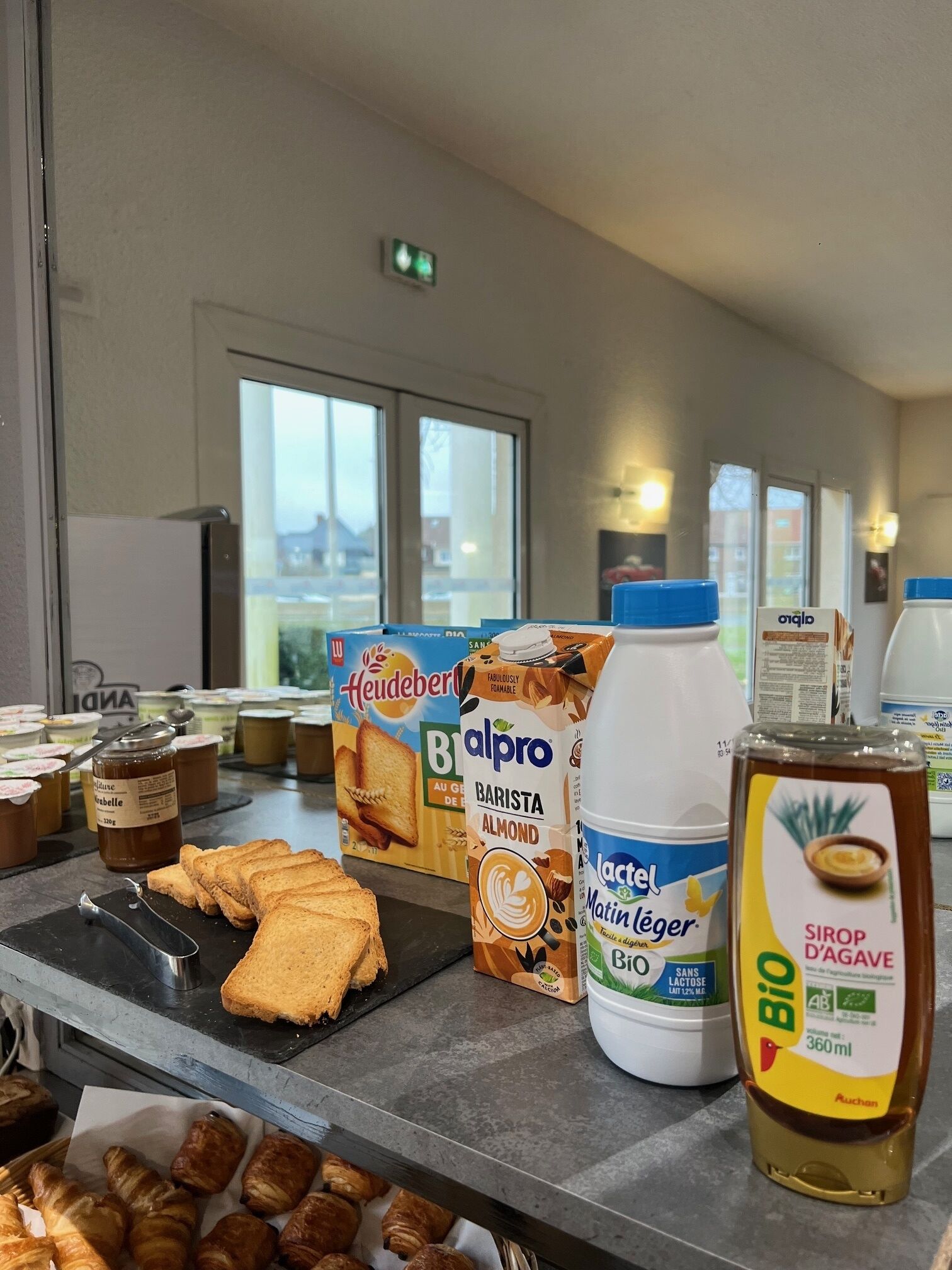 A breakfast bar with various food items and beverages.