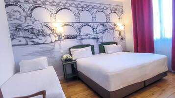 Un dormitorio con una cama grande, dos mesitas de noche y un mural en la pared.