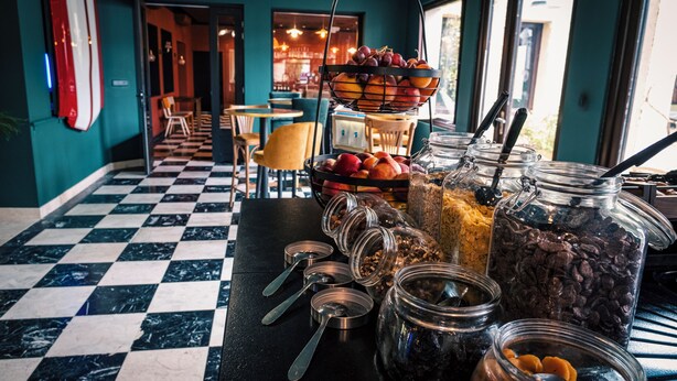 A buffet area with various food items and utensils. - Logis hôtel Les Vignes Blanches (Beaucaire)