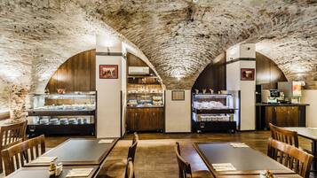 A restaurant with arched ceilings and wooden furniture.