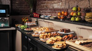 A buffet with various food items and a coffee machine. - Hotel Praga 1 (Prague)