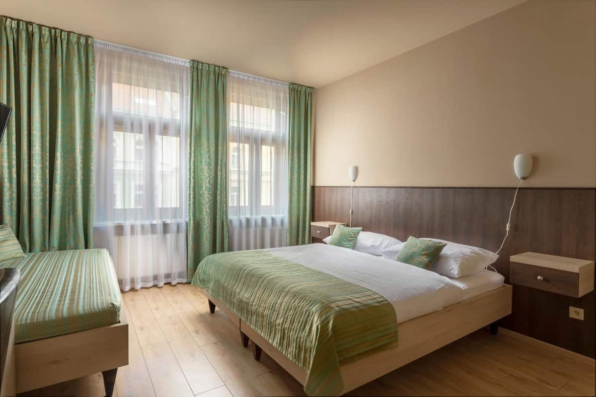 Superior Triple Room | Minibar, in-room safe, desk, laptop workspace
