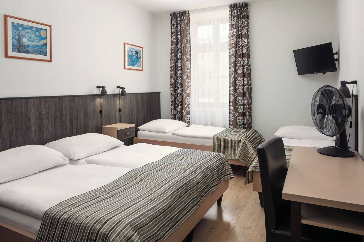 Standard Quadruple Room | Minibar, in-room safe, desk, laptop workspace