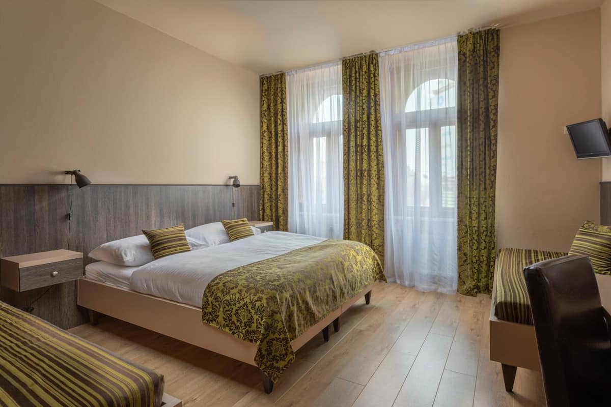Standard Quadruple Room | Minibar, in-room safe, desk, laptop workspace