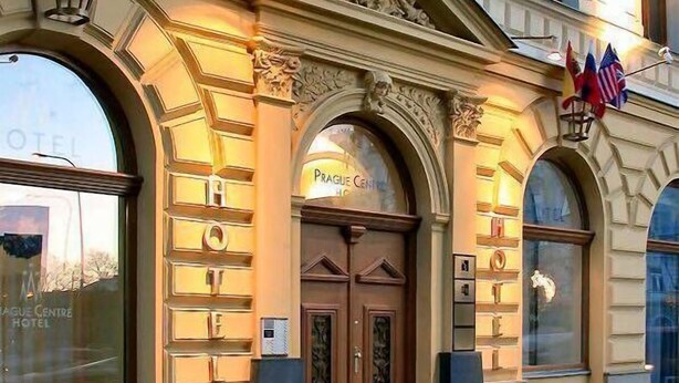 A hotel entrance with a double door, a sign reading "Prague Centre Hotel," and flags above the door. - Hotel Superior Prague (Prague)