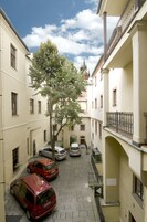 Una stretta via fiancheggiata da edifici e auto parcheggiate.