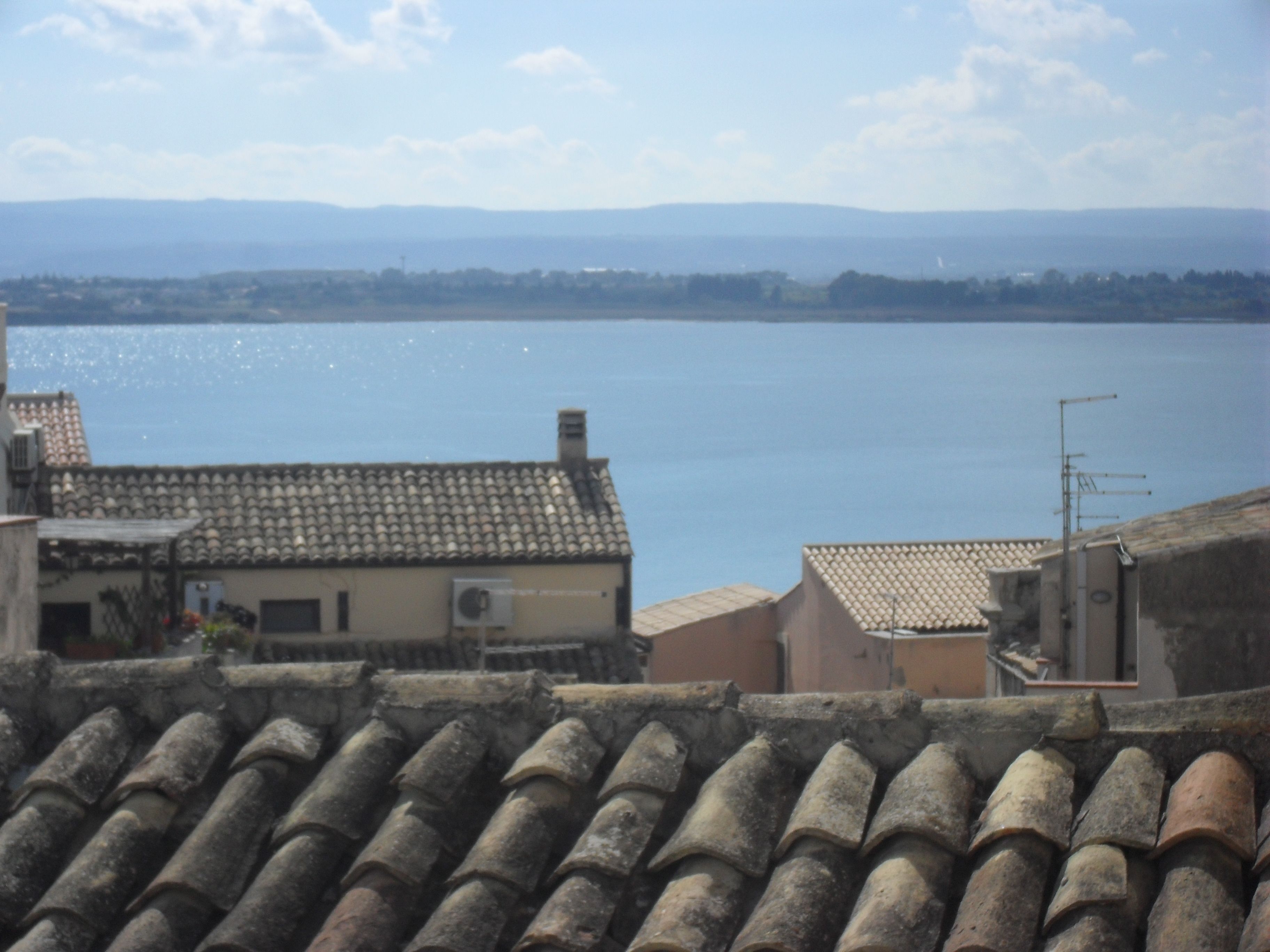 A view of a waterfront with buildings and a clear sky.