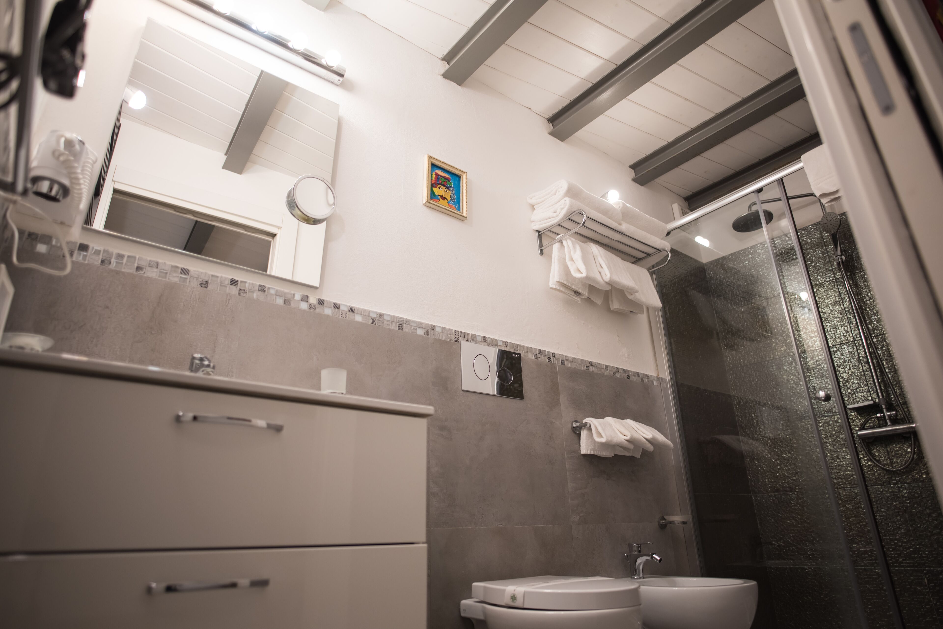 A modern bathroom with a shower, toilet, and sink.