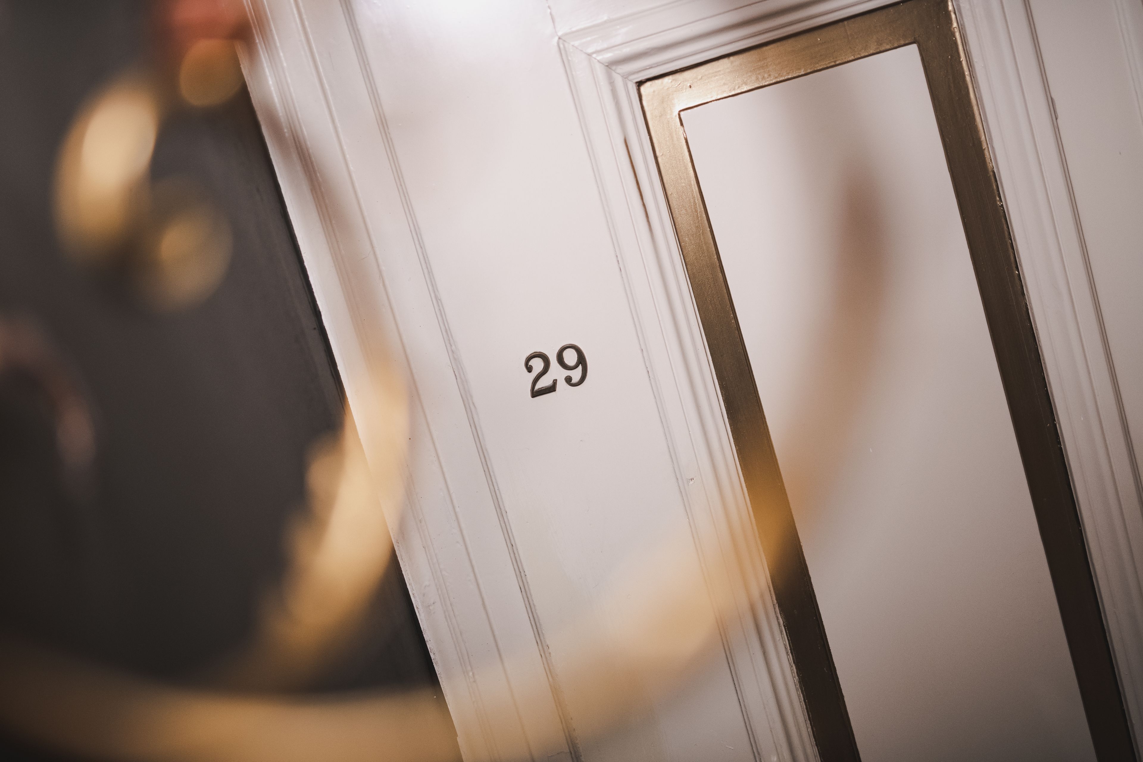 A close-up of a white door with the number 29.