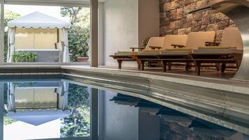 Indoor pool, open 7:00 AM to 7:00 PM, pool loungers