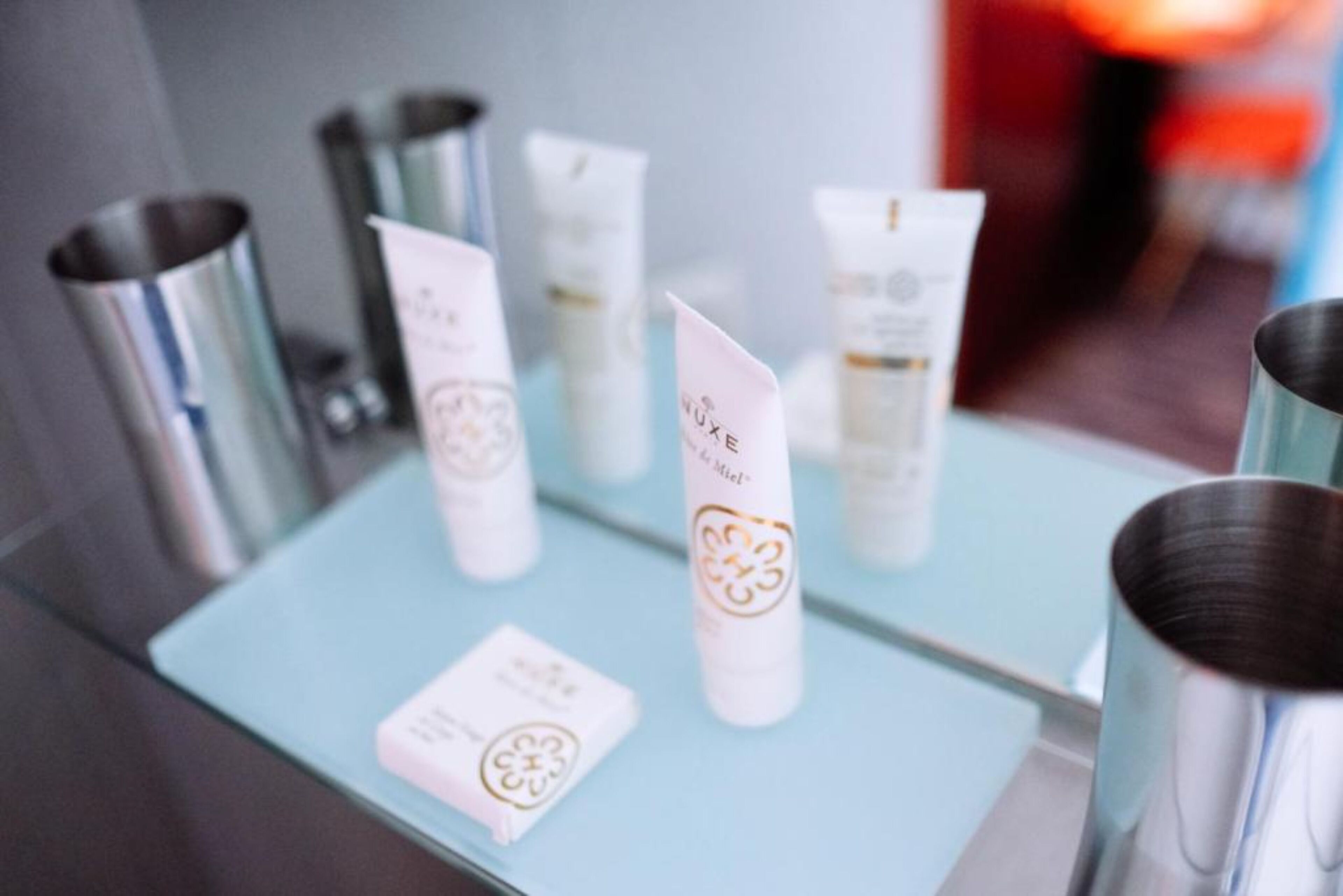 designer toiletries, hair dryer, slippers, towels