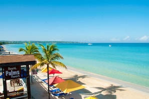 A beach with a resort named "Negril Palms Resort" and a clear blue sea. - Negril Palms (Negril)