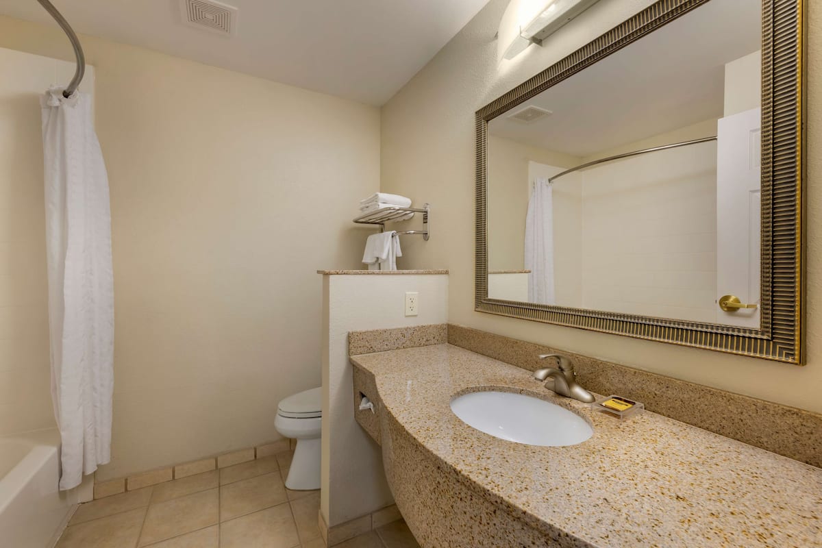 standard room, 2 queen beds, non smoking, refrigerator & microwave | bathroom | combined shower/bathtub, free toiletries, hair dryer, towels
