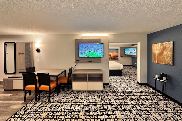 Suite, 1 King Bed, Non Smoking, Refrigerator & Microwave (Larger Room;with Sofabed) | Living area | 50-inch flat-screen TV with satellite channels, streaming services