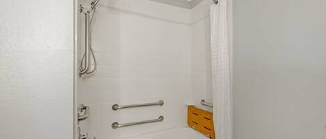 A bathroom with a bathtub, a shower, and a toilet.
