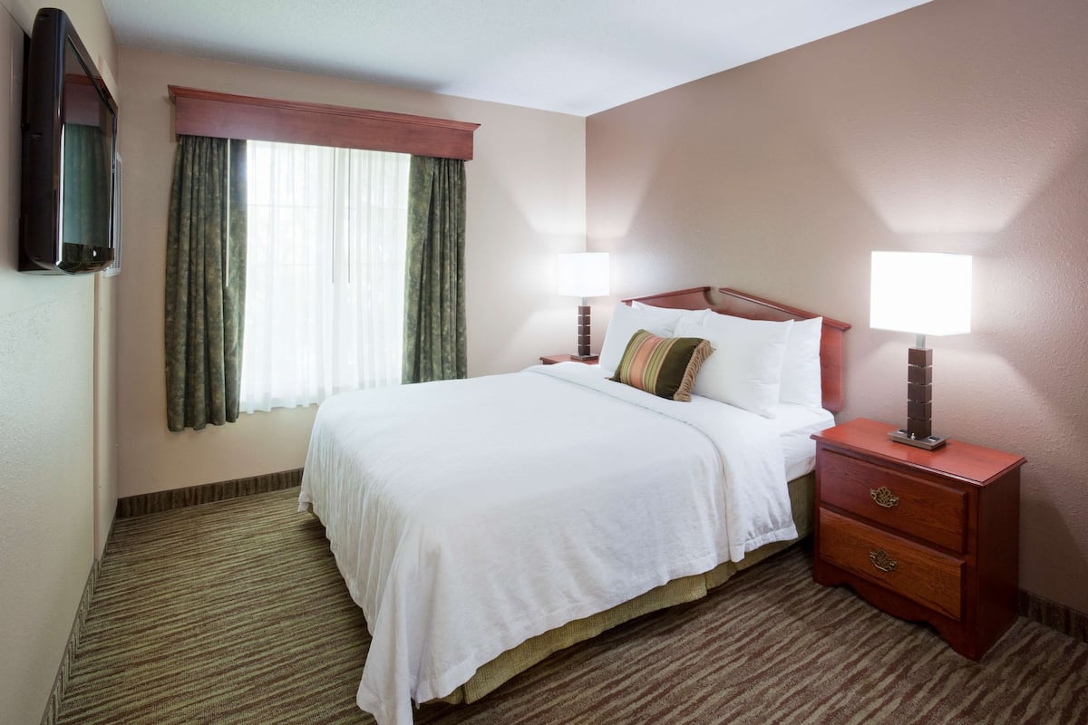 Premium bedding, desk, laptop workspace, blackout drapes
