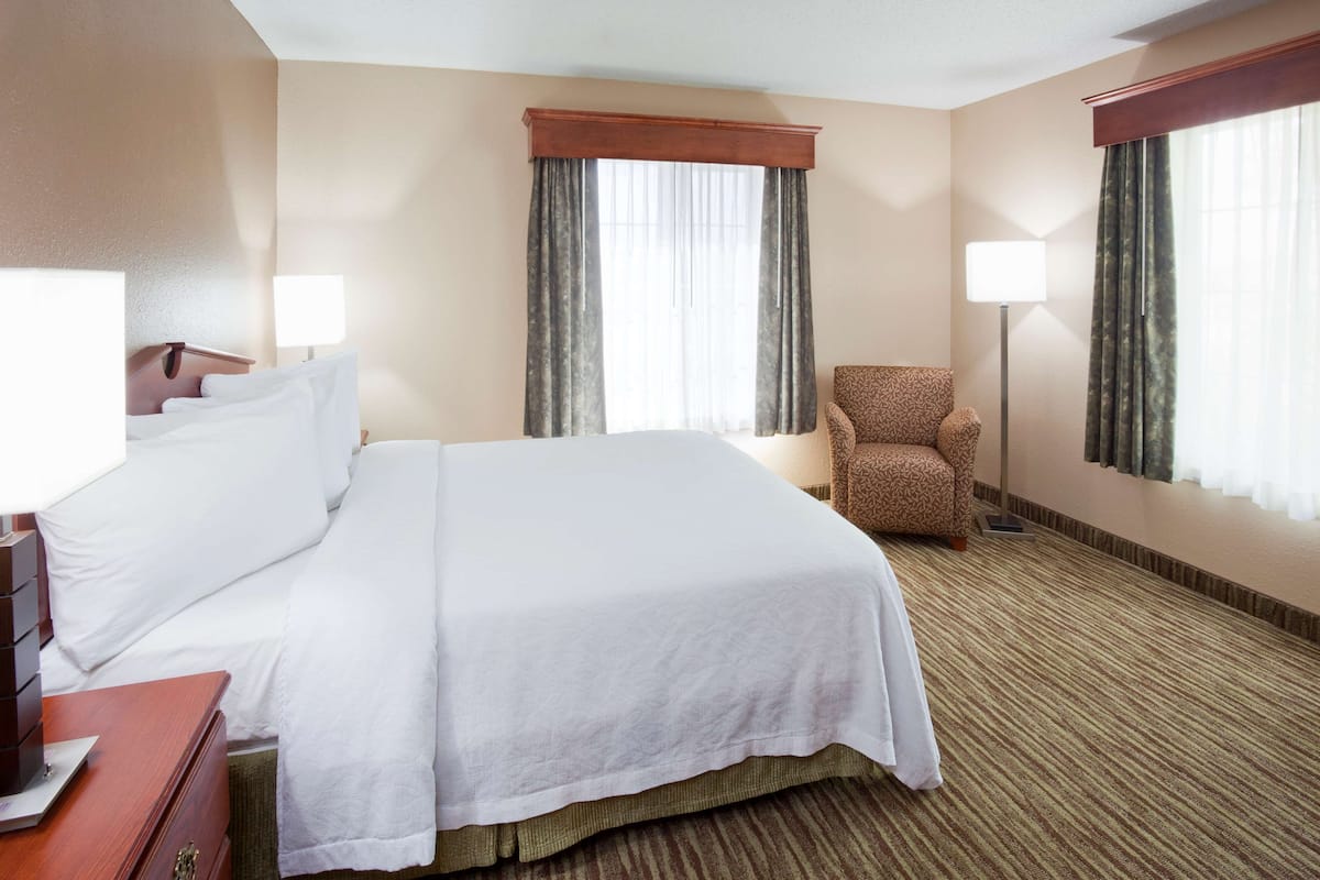 Premium bedding, desk, laptop workspace, blackout drapes