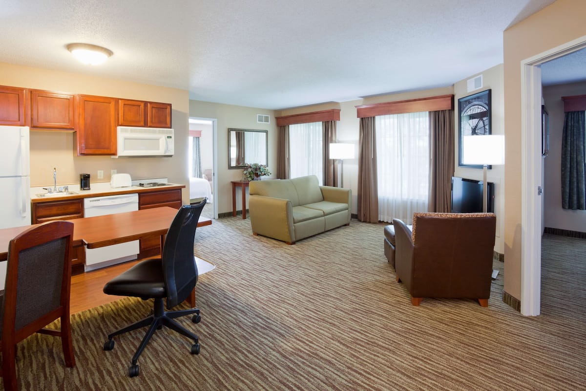Premium bedding, desk, laptop workspace, blackout drapes