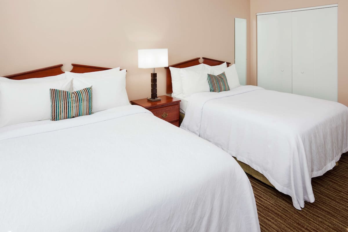 Premium bedding, desk, laptop workspace, blackout drapes