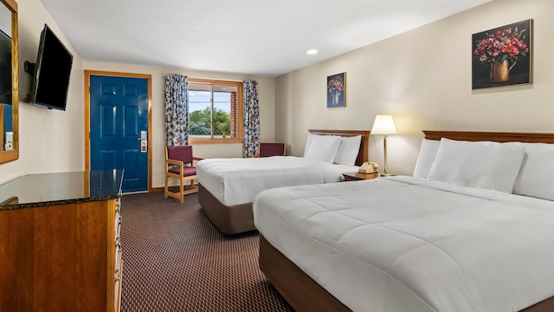 A hotel room with two beds, a desk, a chair, a TV, and a window with curtains. - Americas Best Value Inn Biddeford Portland (Biddeford)