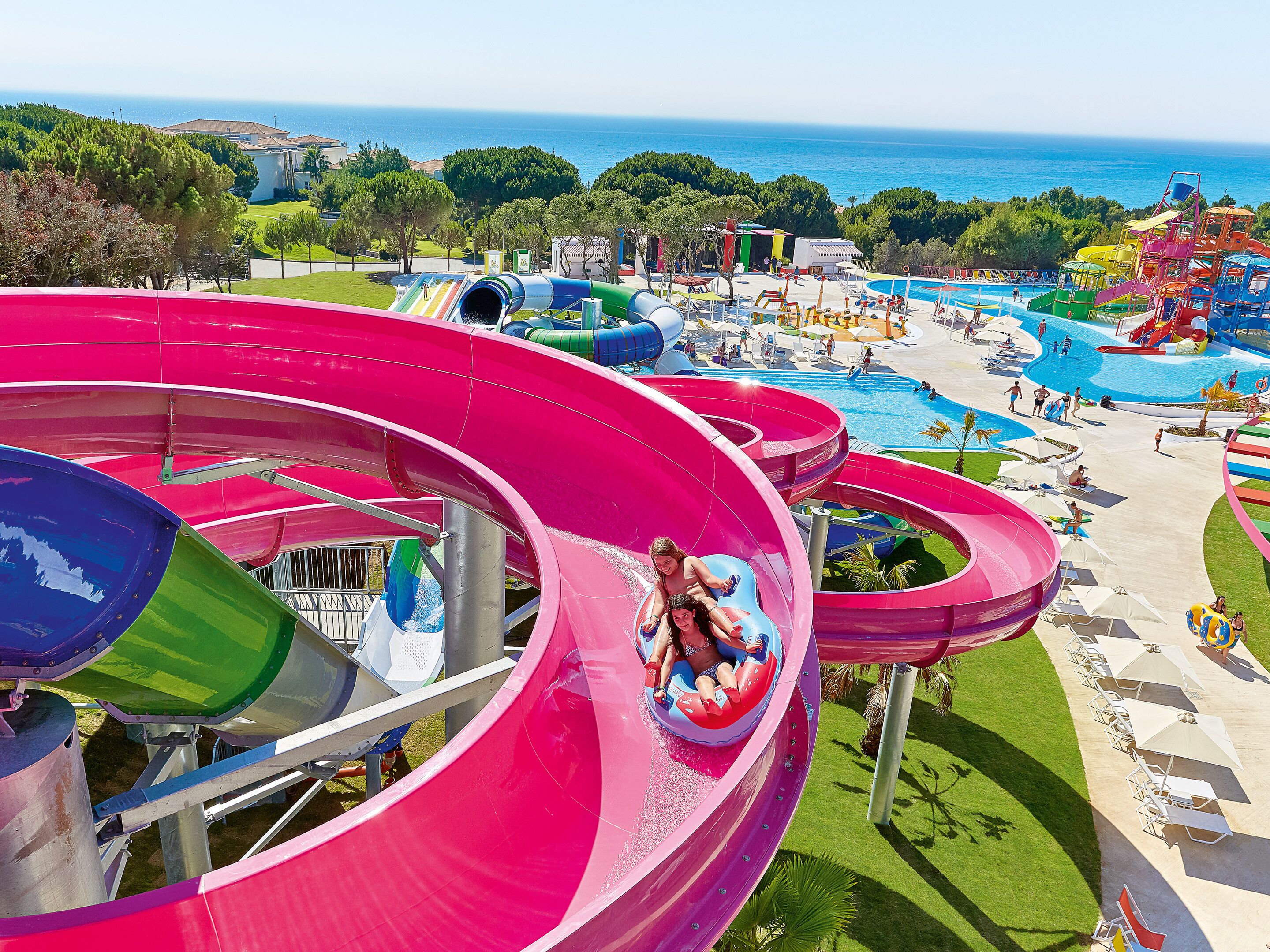 A water park with multiple water slides and a pool area.