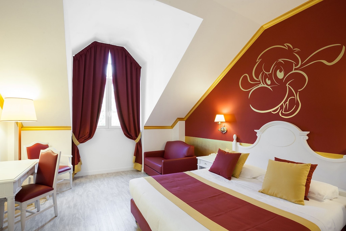Een hotelkamer met een bed, een bureau, een stoel en een raam met gordijnen.