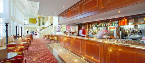 A bar area with a bartender, wooden bar counter, and seating area with tables and chairs.