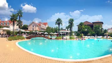 Relax by the clear blue pool surrounded by a scenic walkway.