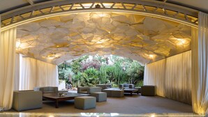 An indoor garden with seating areas and a glass floor.