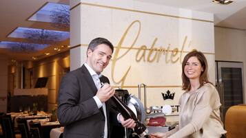 A man and woman in a restaurant with a wall sign reading "Gabriel's".