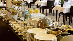 A buffet setup with various food items and beverages.