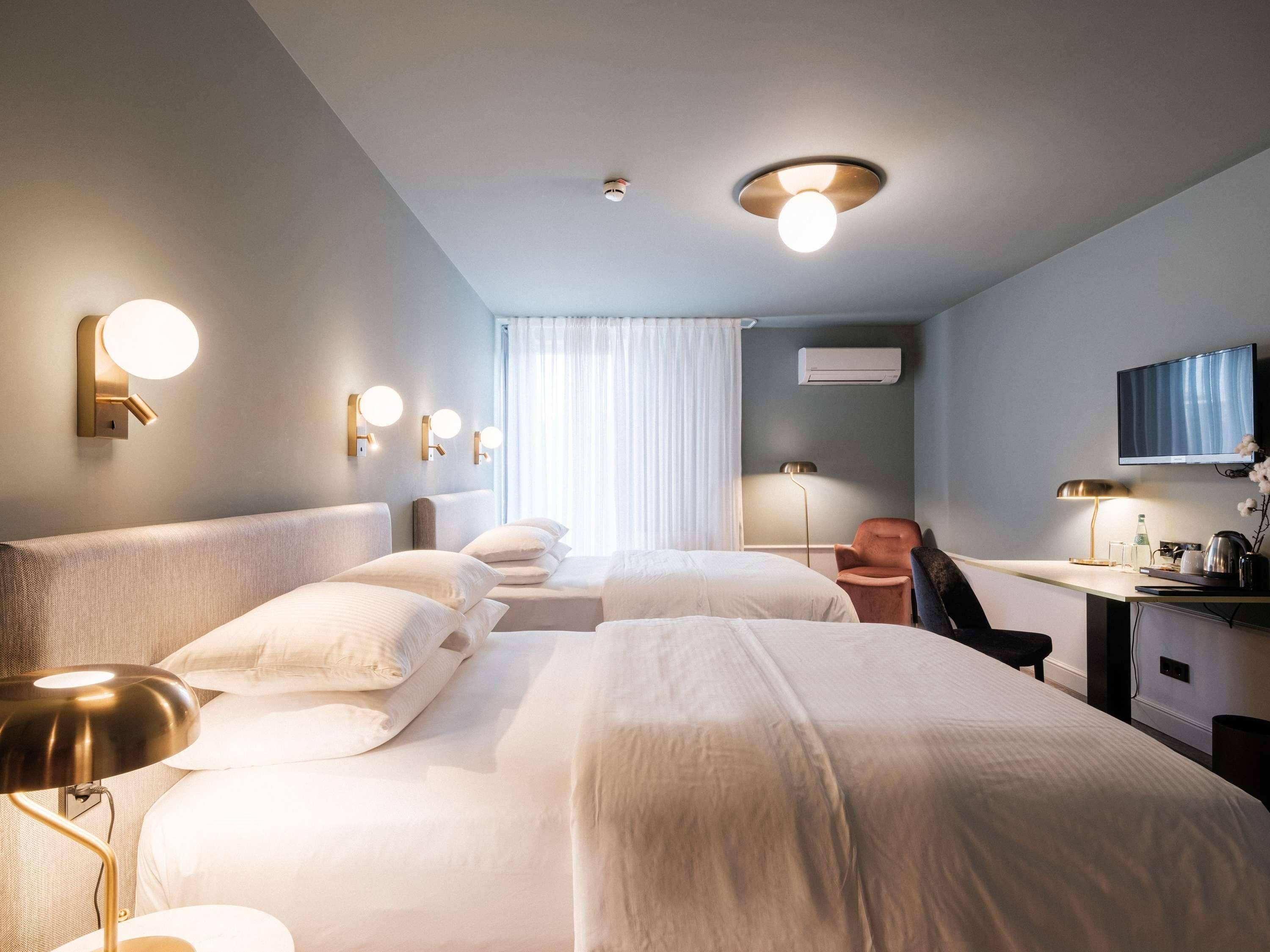 Hypo-allergenic bedding, desk, laptop workspace, blackout drapes