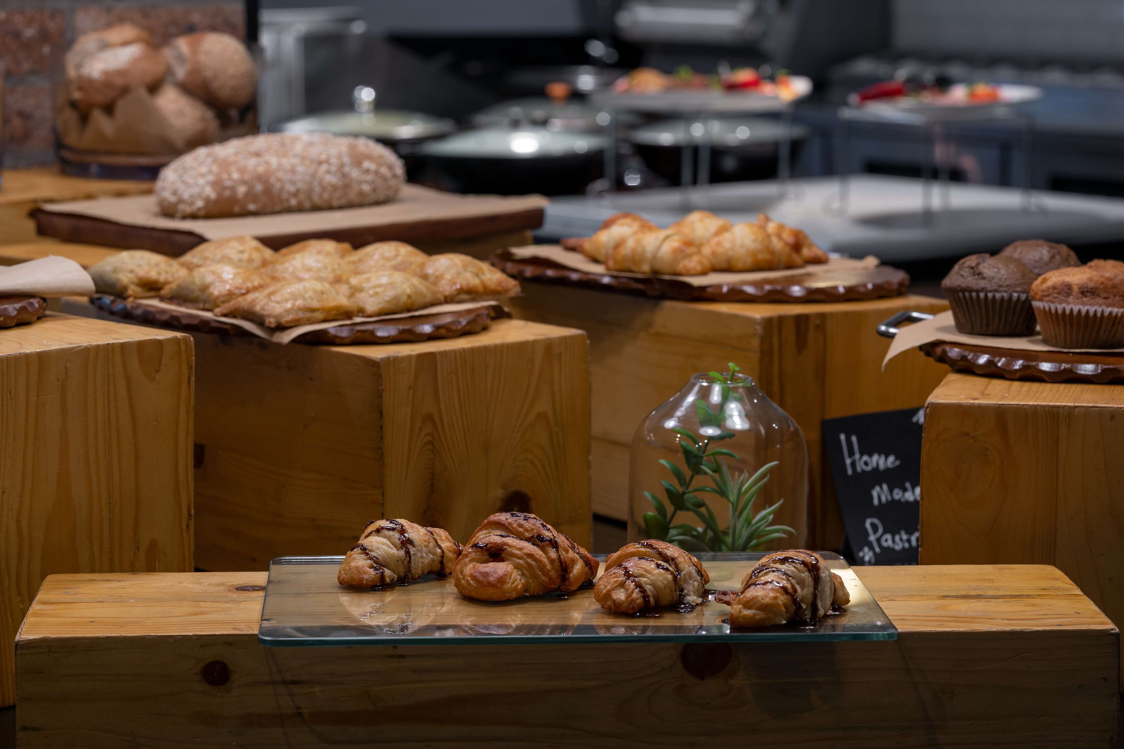 Eine Bäckereireihe mit verschiedenen Backwaren, darunter Croissants und Muffins.