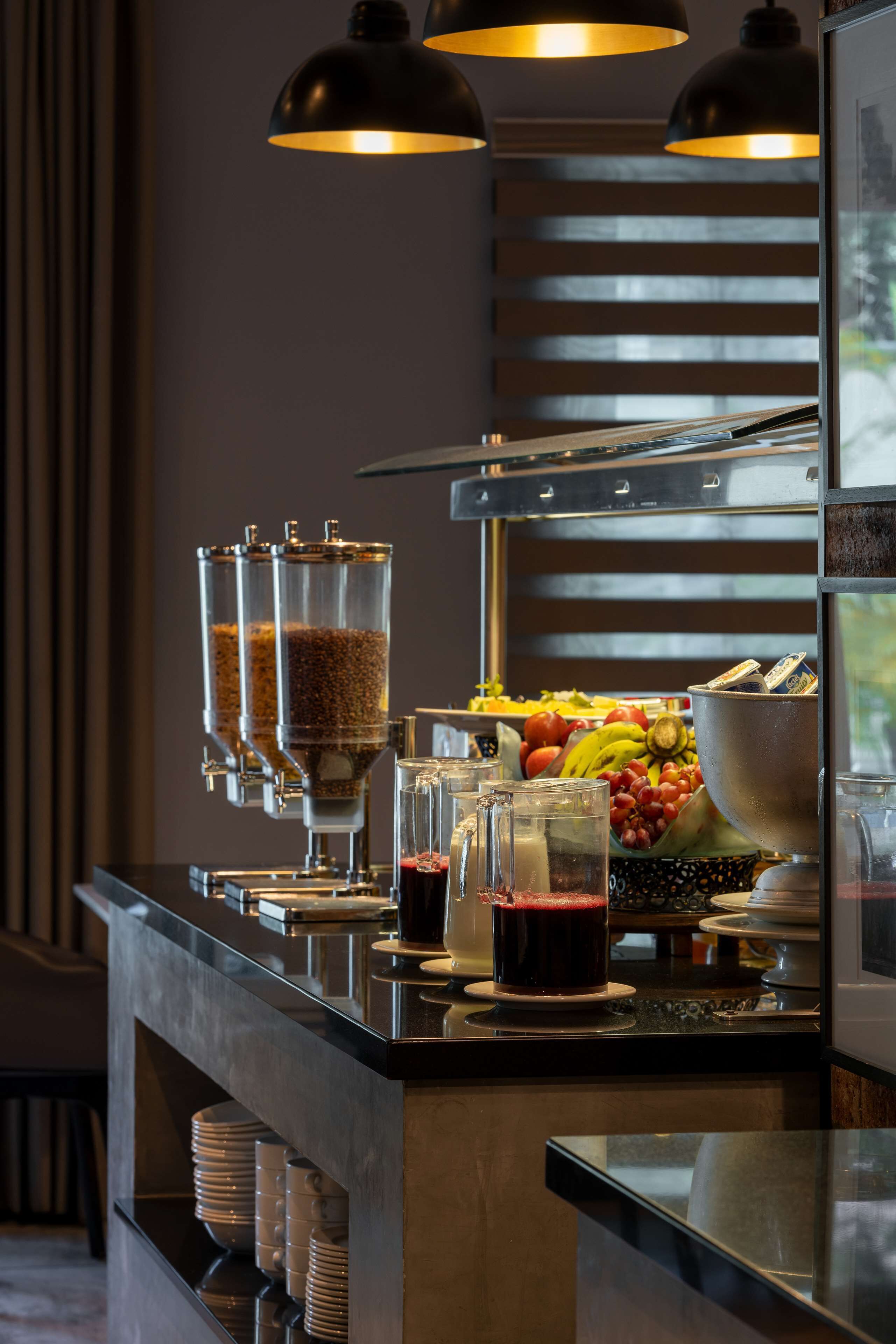 A buffet setup with various food items and beverages.