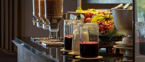 A buffet setup with various food items and beverages.