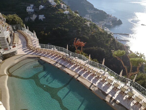 Outdoor pool, open 9:00 AM to 6:00 PM, pool umbrellas, pool loungers