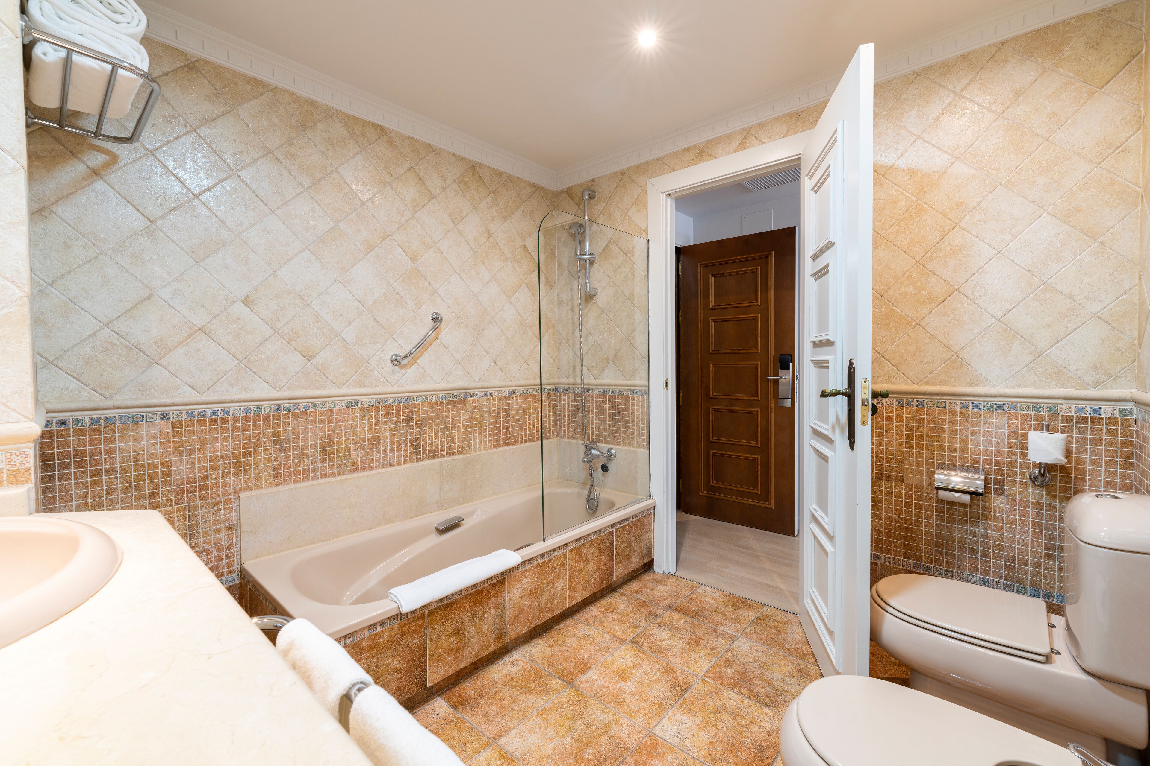 A bathroom with a bathtub, toilet, and sink.