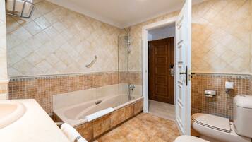 A bathroom with a bathtub, toilet, and sink.